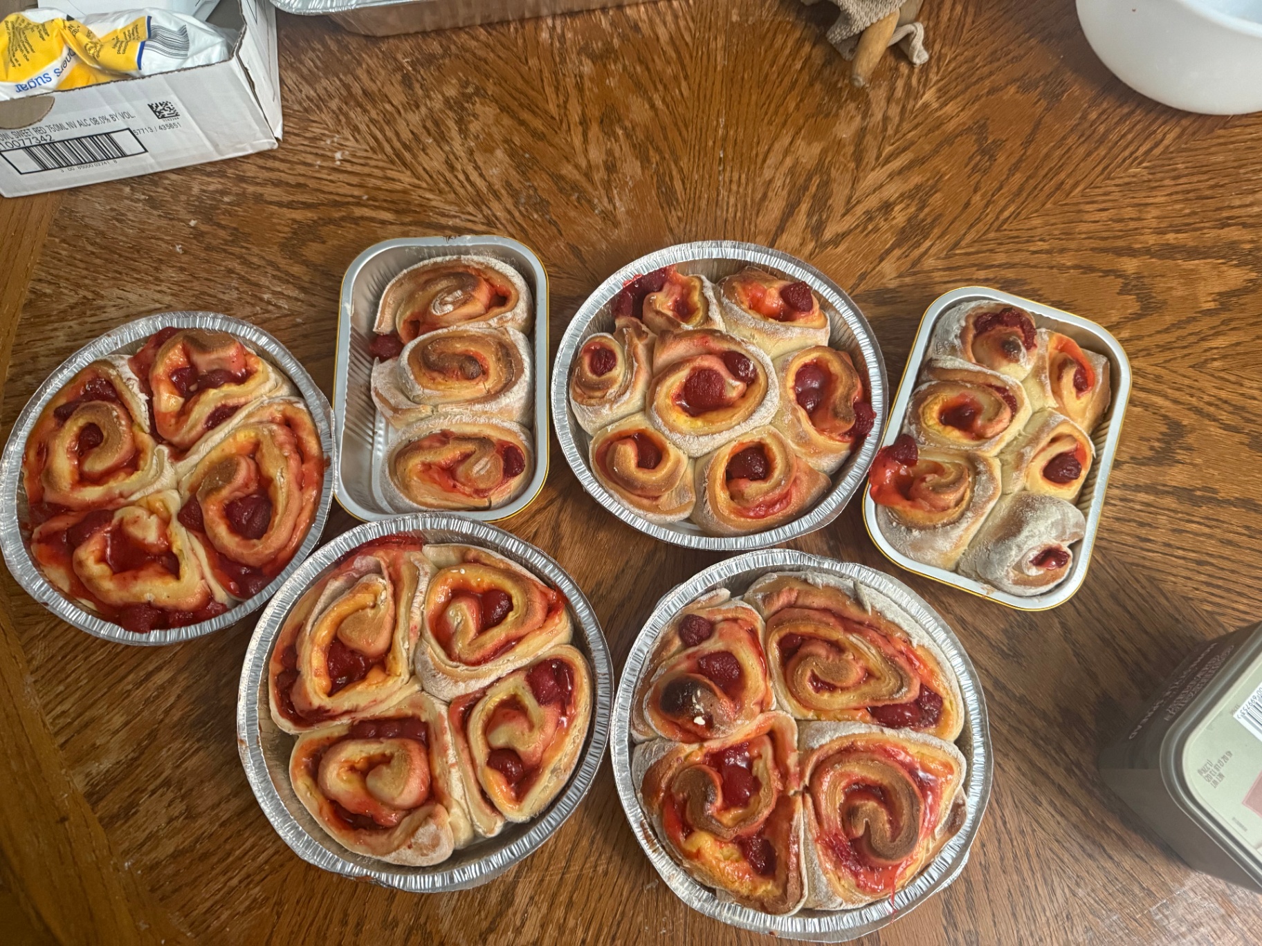 Strawberry cheesecake sweet rolls in multiple pans